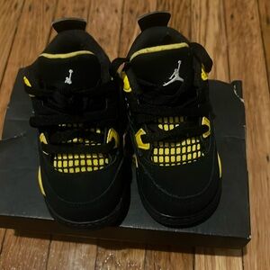 Black and yellow Jordan’s 4
